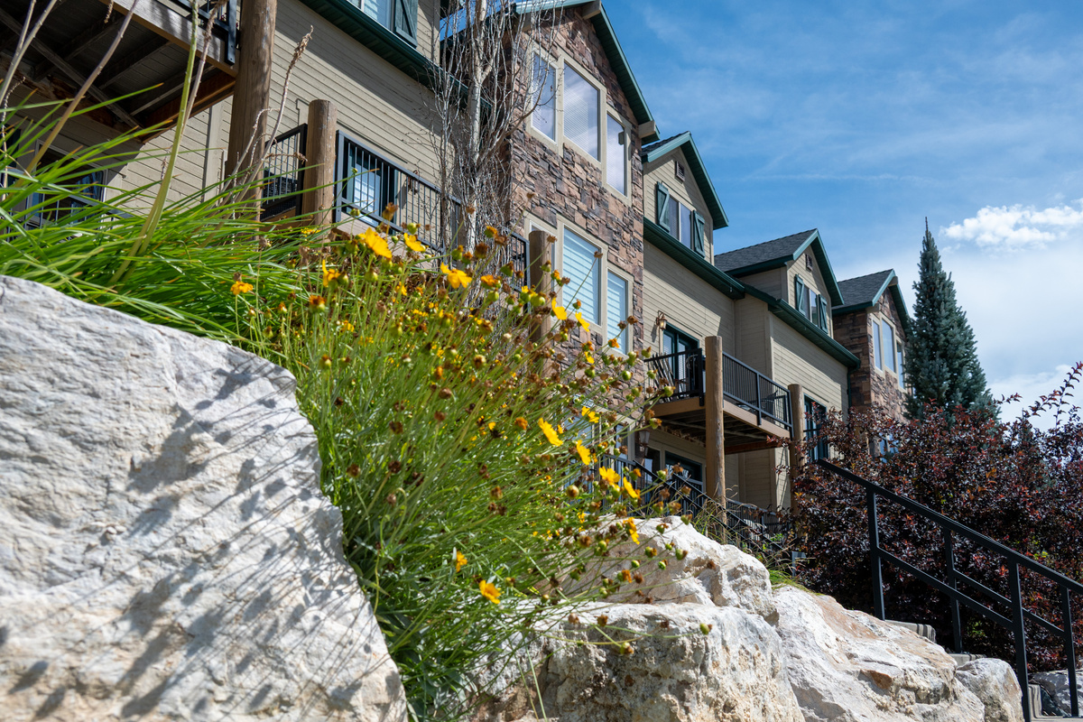 Landscaped walkways and natural surroundings create a welcoming entrance.