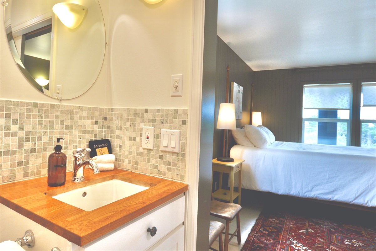 Downstairs bedroom: king bed, ocean views, smart TV, en suite bathroom with walk-in shower.