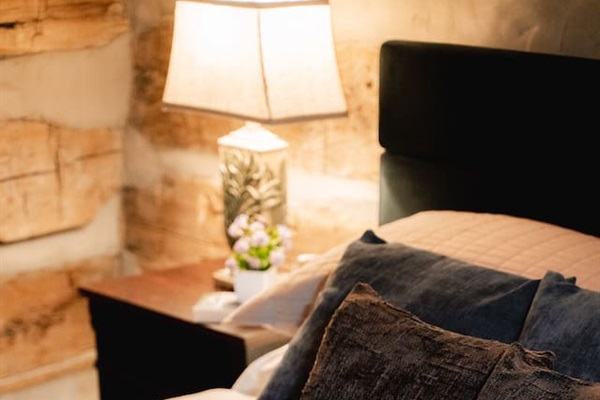 A bedroom with soft lighting and a comfortable bed, perfect for unwinding after a day of adventure.