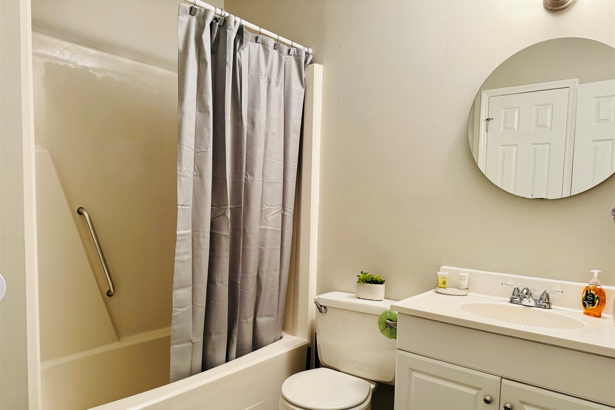 Main Floor bathroom with access from King Bedroom #1 and common area. This bathroom features a shower tub combo. 