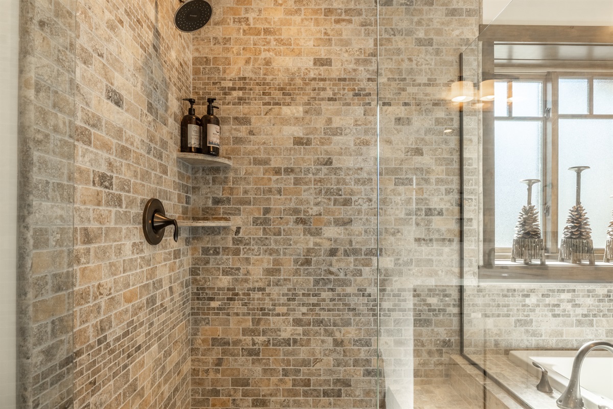 Beautifully finished with statement tile, this en-suite bathroom features a soaking tub and a separate toilet room, giving you space, privacy, and a little extra breathing room at the start and end of the day.