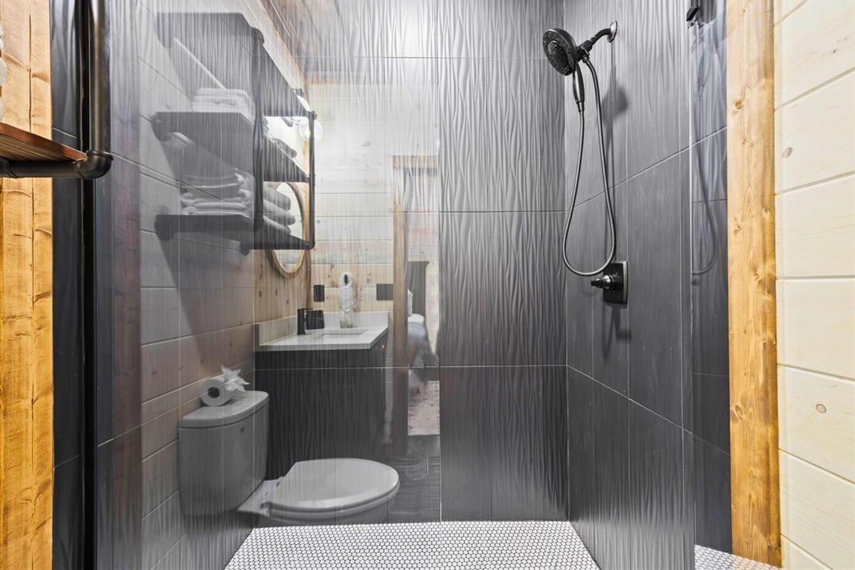 Luxurious shower with dark tile accents for a spa-like feel.