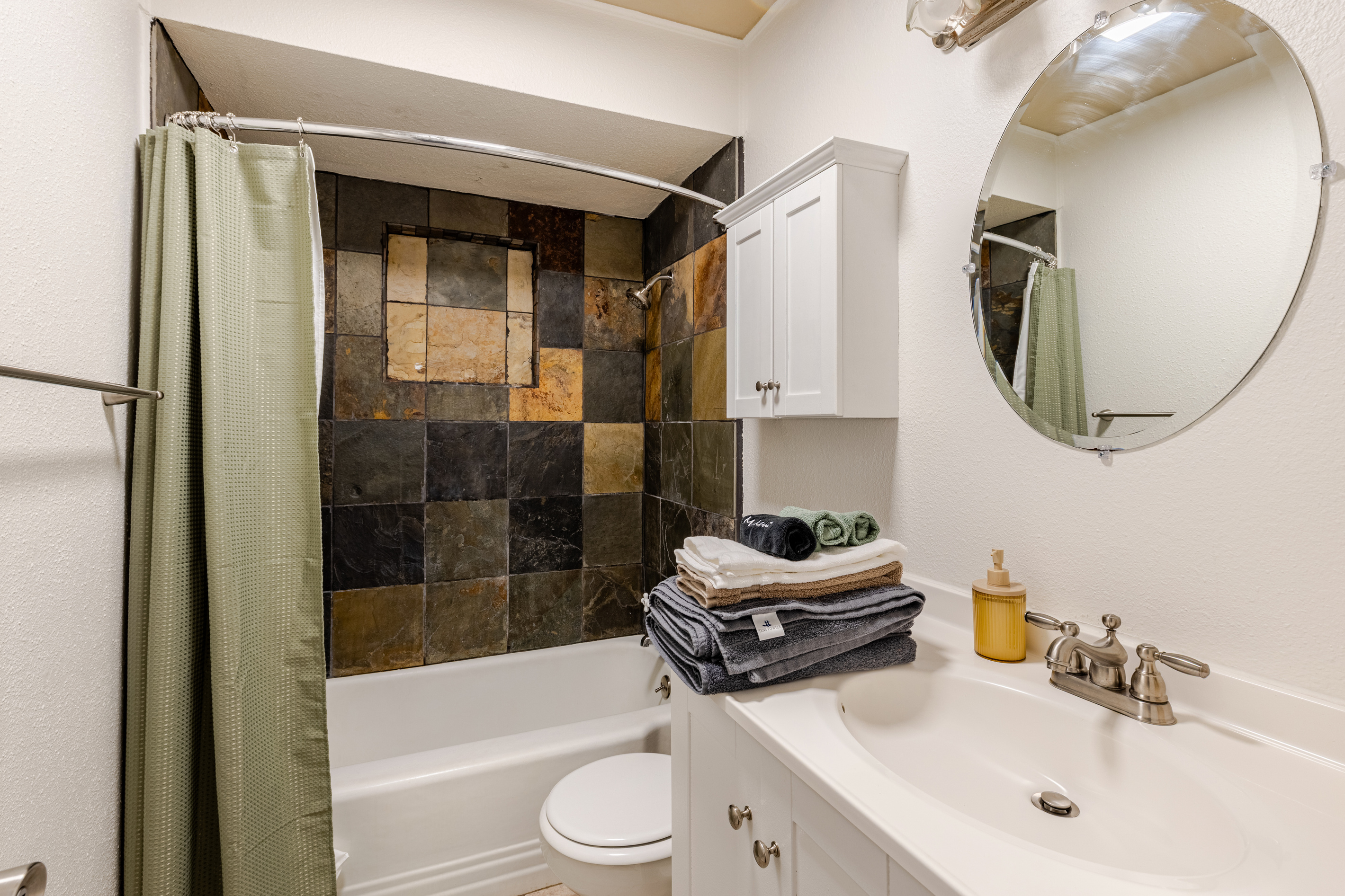 Unwind in a chic space with unique tiles and plush linens at your fingertips!