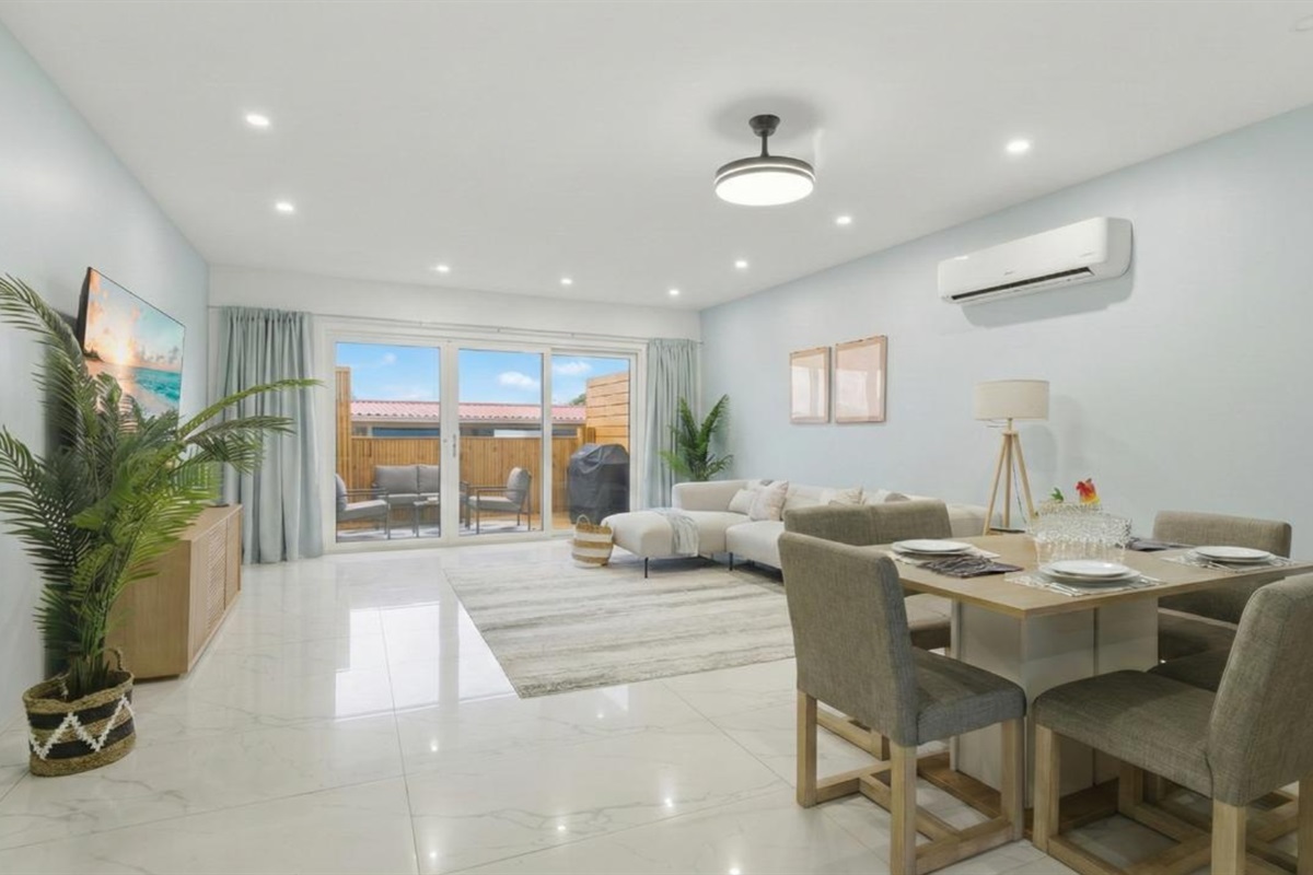 Relax in this airy living room with plush sectional and serene décor