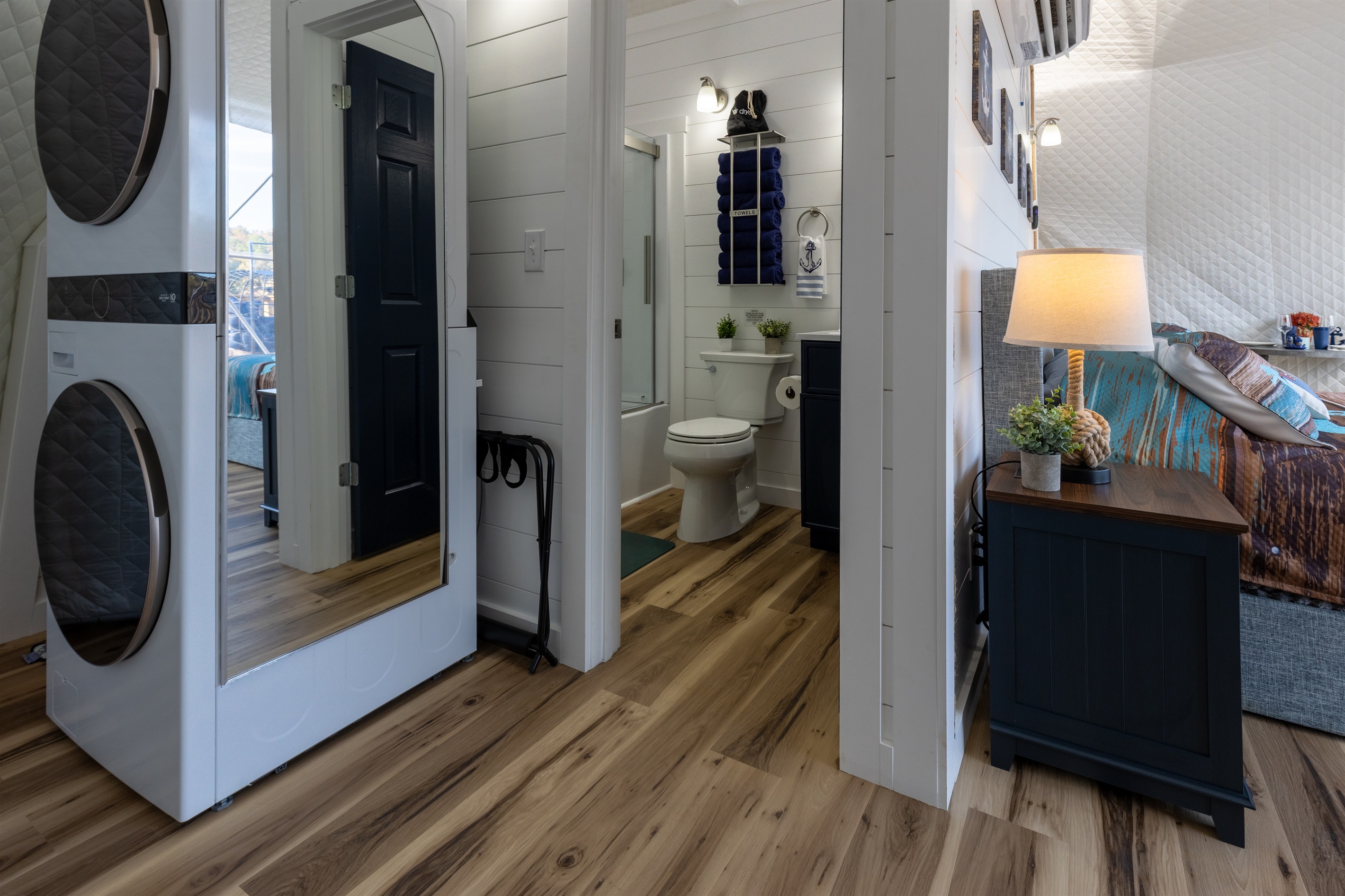 Private full bathroom with sliding glass shower, plush towels, and an in-unit washer/dryer for extended stays