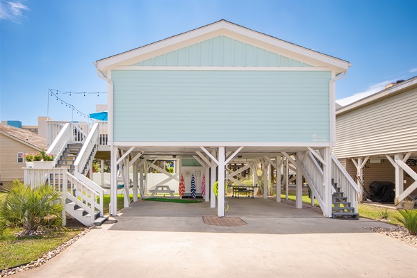 Plenty of parking, the driveway can fit up to 4 vehicles (2 under house, 2 outside) as well as plug for golf cart charging.