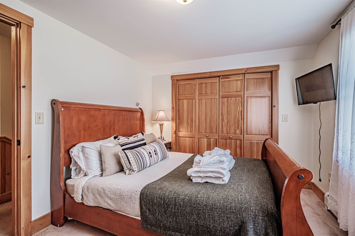 Queen bedroom with cozy furnishings for a good night’s sleep.