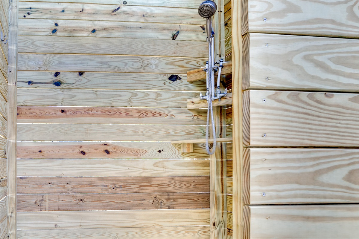 A thoughtfully built outdoor shower for a relaxed coastal feel&mdash;great for sandy feet, swimsuits, and kids