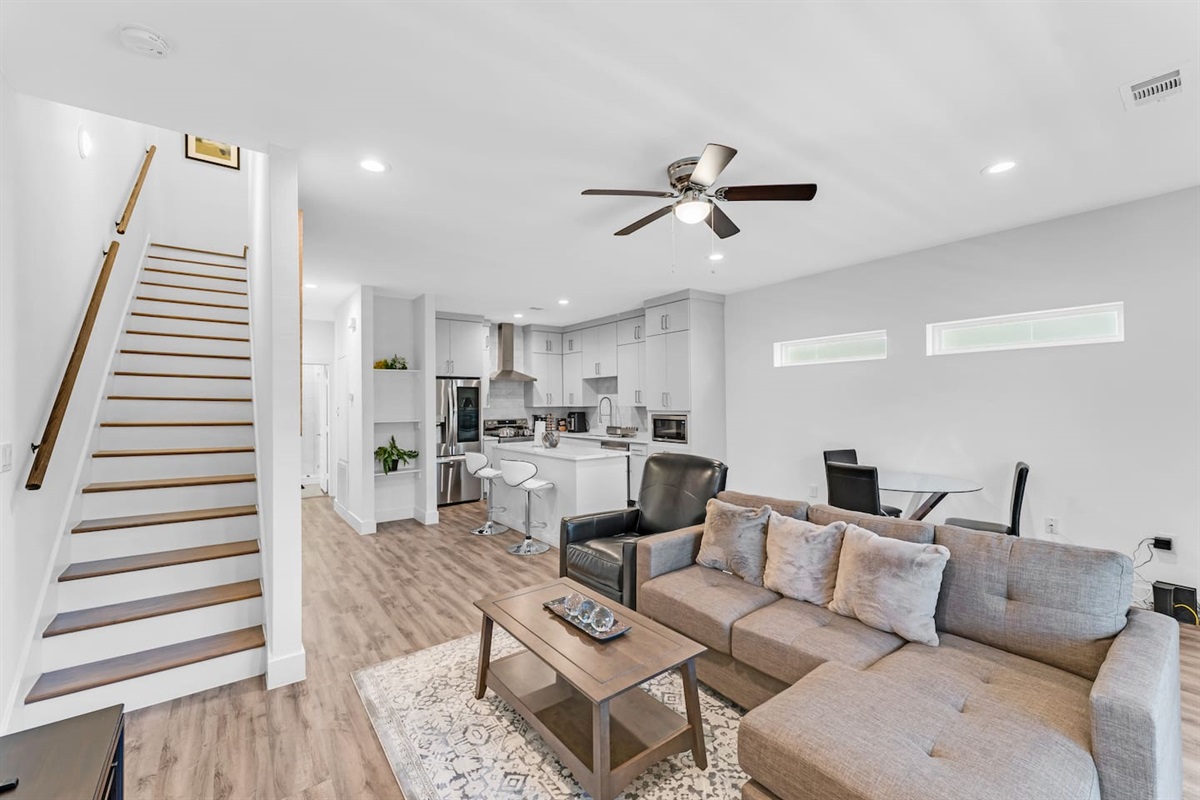 Bright open-concept layout connecting living, dining, and kitchen spaces—ideal for families and groups to relax and reconnect.