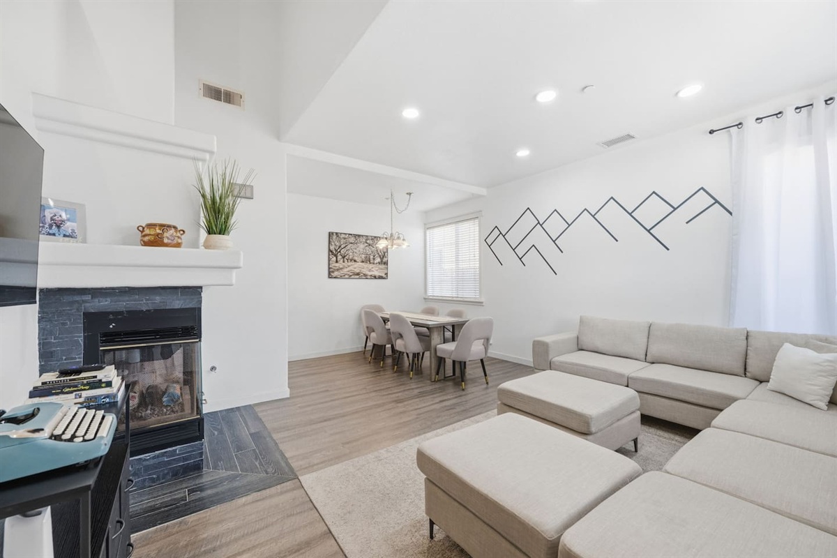 Open-concept living room with gas fireplace, Smart TV, and ample seating for 10 guests. Two-story family beach house near Oxnard Beach and Channel Islands Harbor.