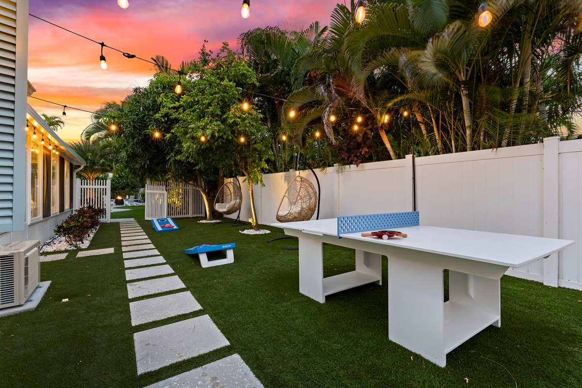 Magical evenings in the yard. String lights illuminate the lush yard and outdoor game area, providing a stunning backdrop for nighttime fun.