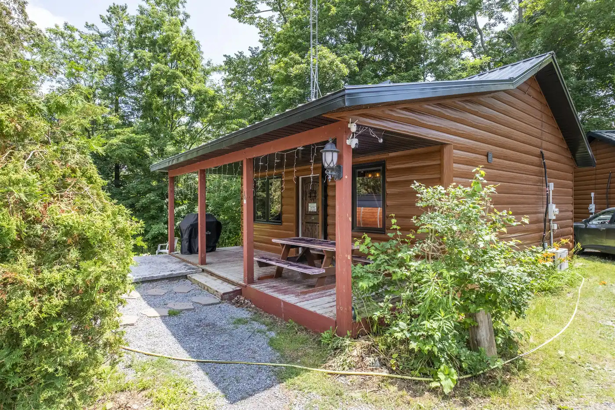 Front exterior of Cottage #4 surrounded by mature greenery