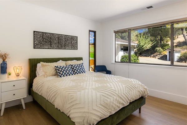 Bedroom 3 features a Queen memory foam bed and beautiful stained glass windows