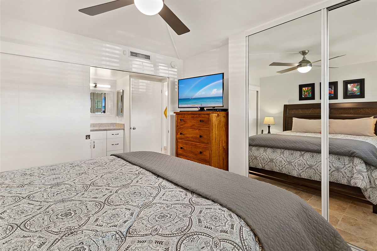 The bedroom has a California king size bed and TV and is connected to the bathroom