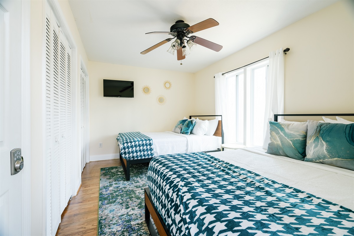 Main level bedroom (BR 1) with 2 queen beds & TV