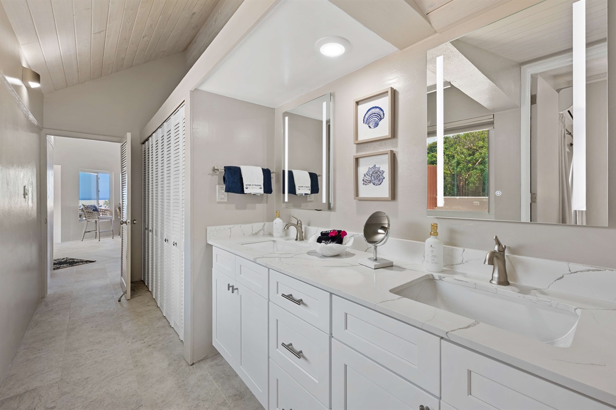 Guest ensuite bathroom with dual vanities and shower