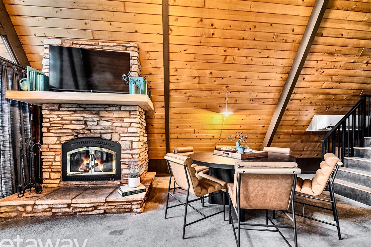 Cozy fireplace + dining space for meals and game nights