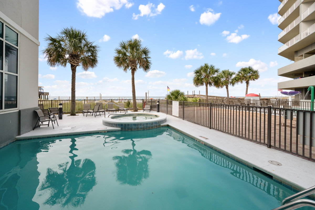 Outdoor pool and hot tub area beside the Gulf.