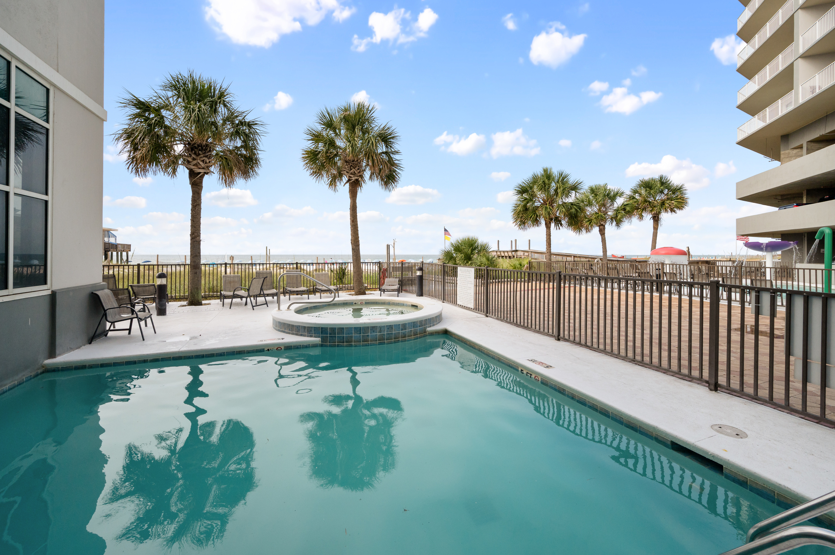 Outdoor pool and hot tub area beside the Gulf.