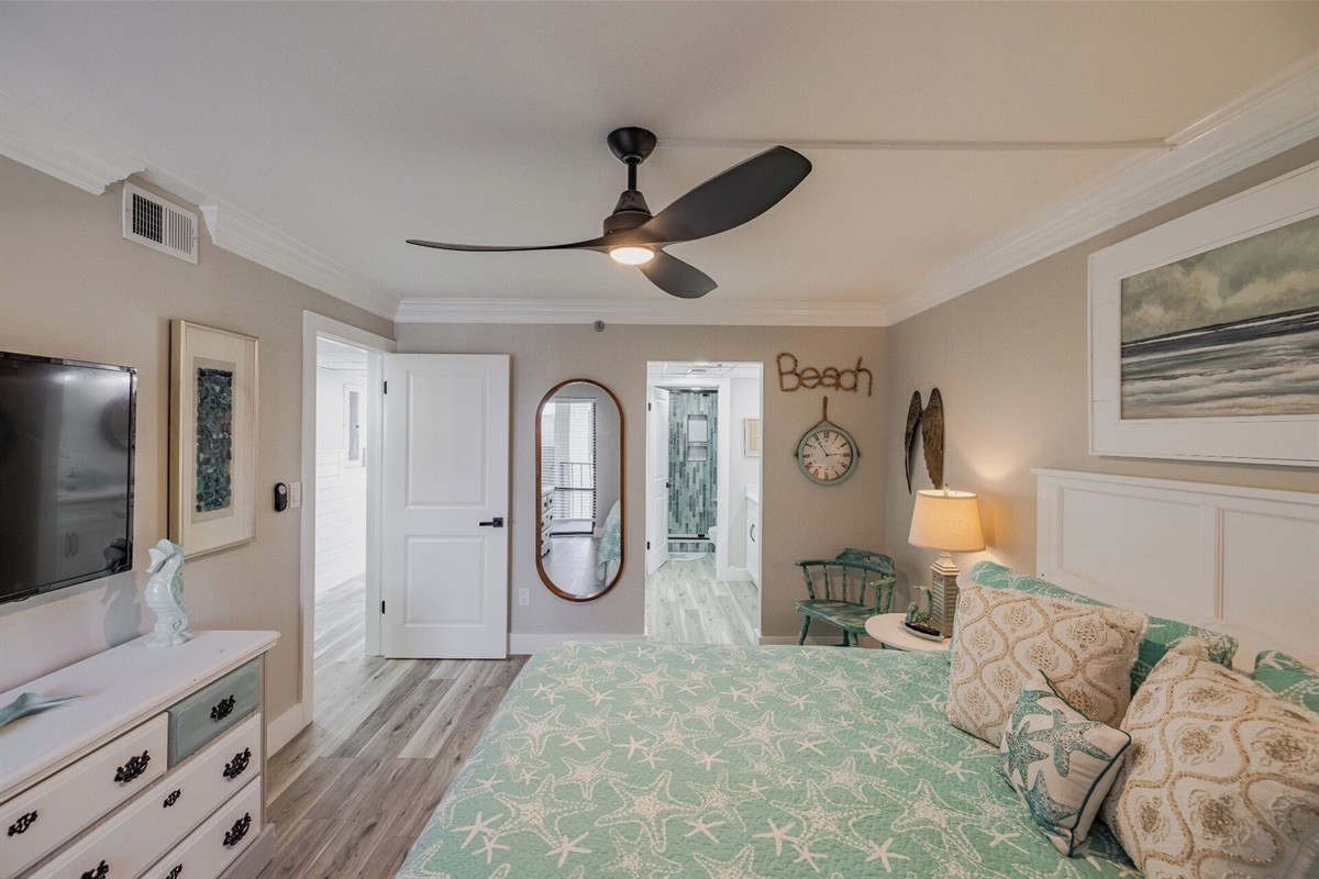 Master bedroom with king bed, ceiling fan, smart TV and ensuite bathroom