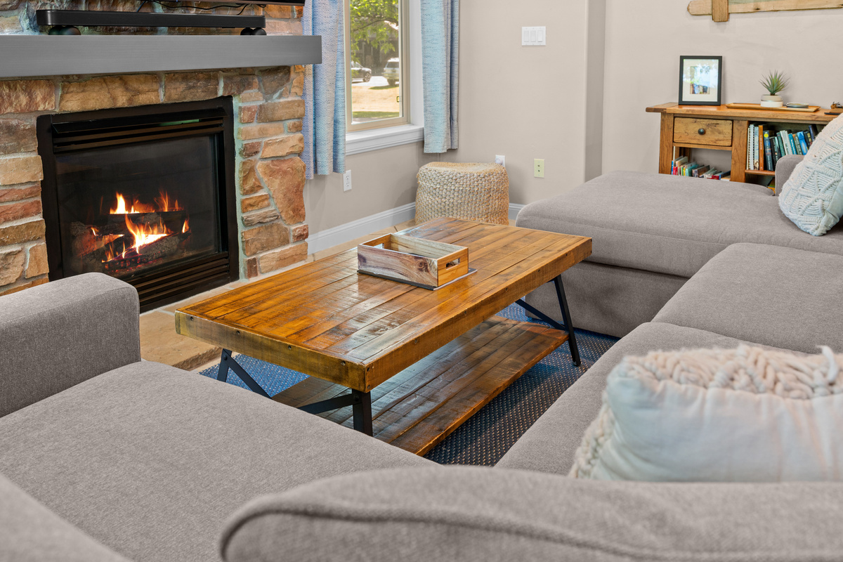 Lounge in the new comfortable 12-foot-long couch that surrounds the fireplace.
