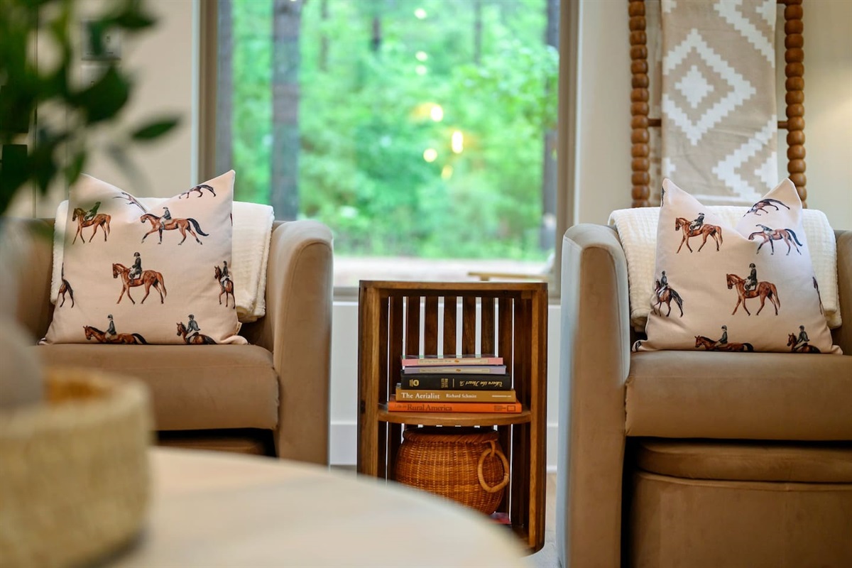 Sink into rich brown velvet and equestrian elegance — these cozy chairs with matching ottomans and rider-accented pillows are the perfect blend of comfort and character..