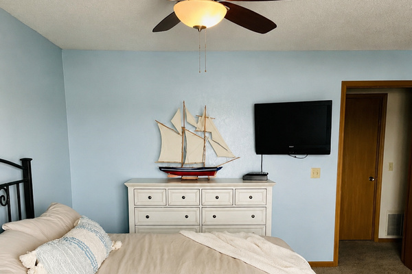 Bedroom with wall-mounted television