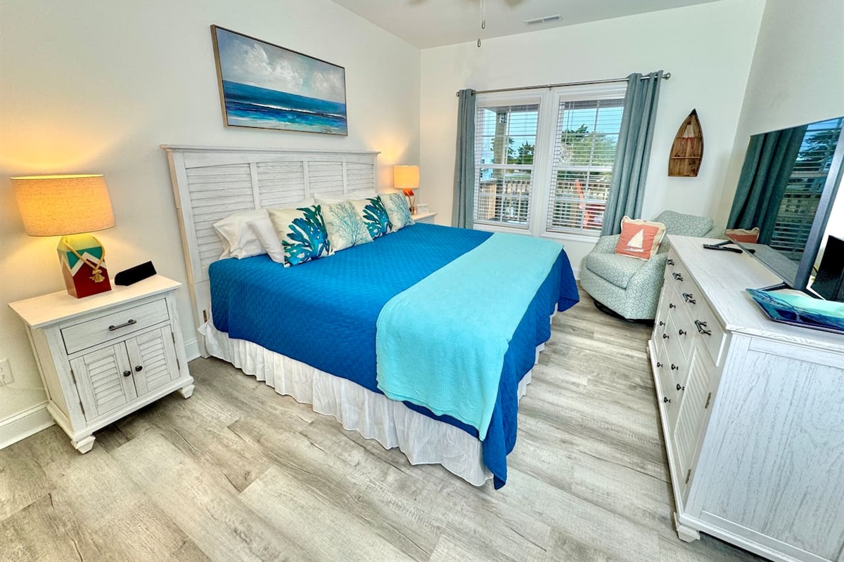 The master bedroom has a King bed, smart TV, blackout curtains, and water view.