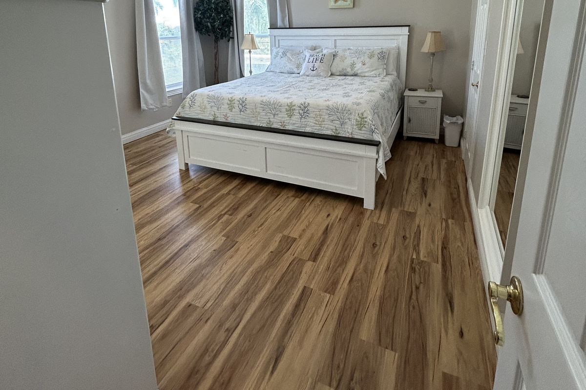 Spacious King Suite with ensuite bath and balcony access overlooking the lush backyard oasis.