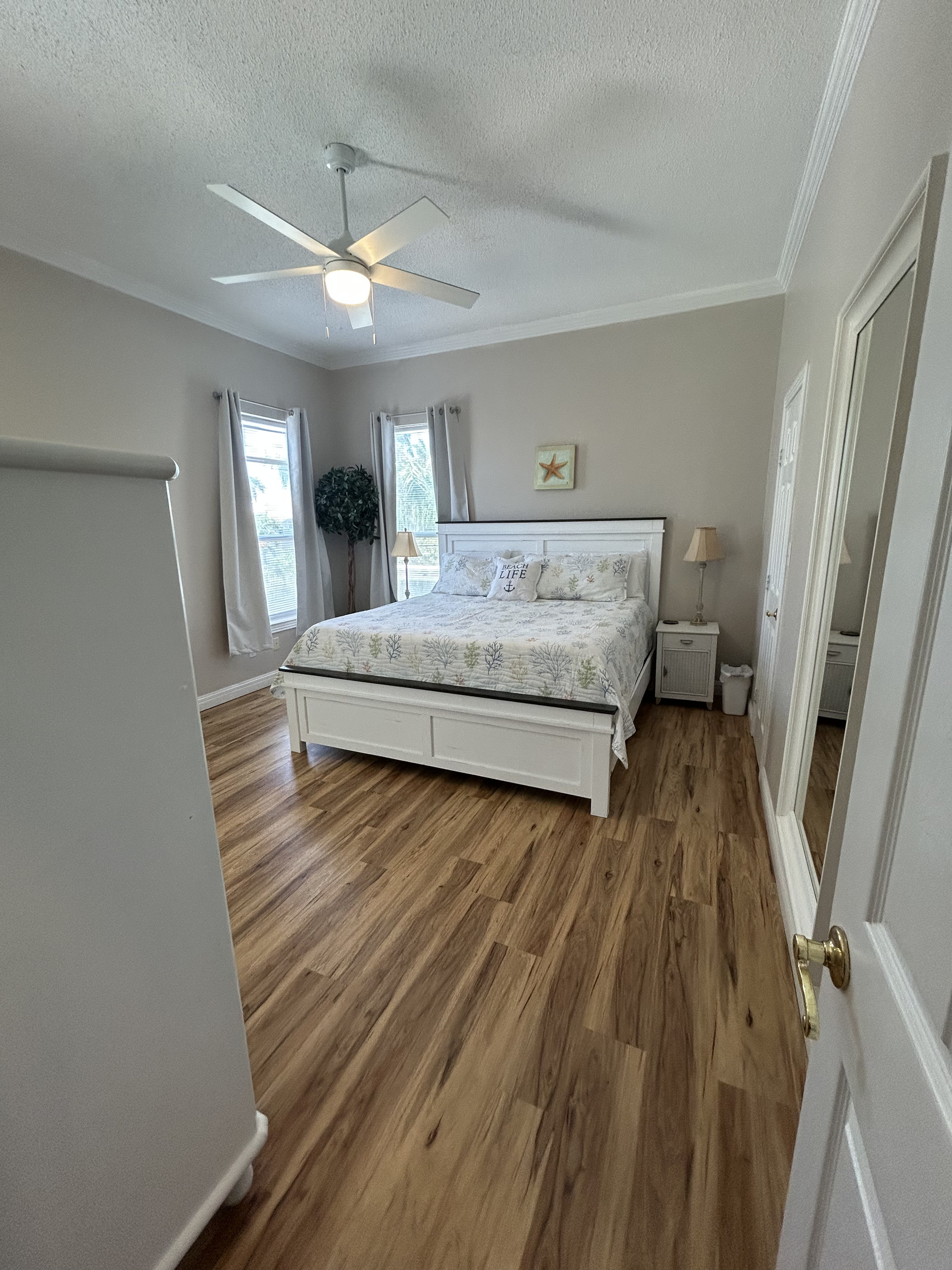 Spacious King Suite with ensuite bath and balcony access overlooking the lush backyard oasis.
