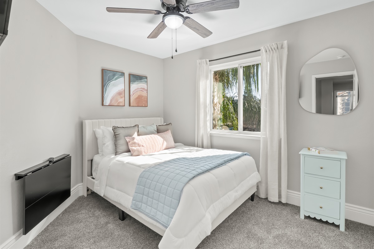 Bright and cozy bedroom with soft carpeting, a comfortable bed, and plenty of natural light—perfect for restful nights after a full day of fun.