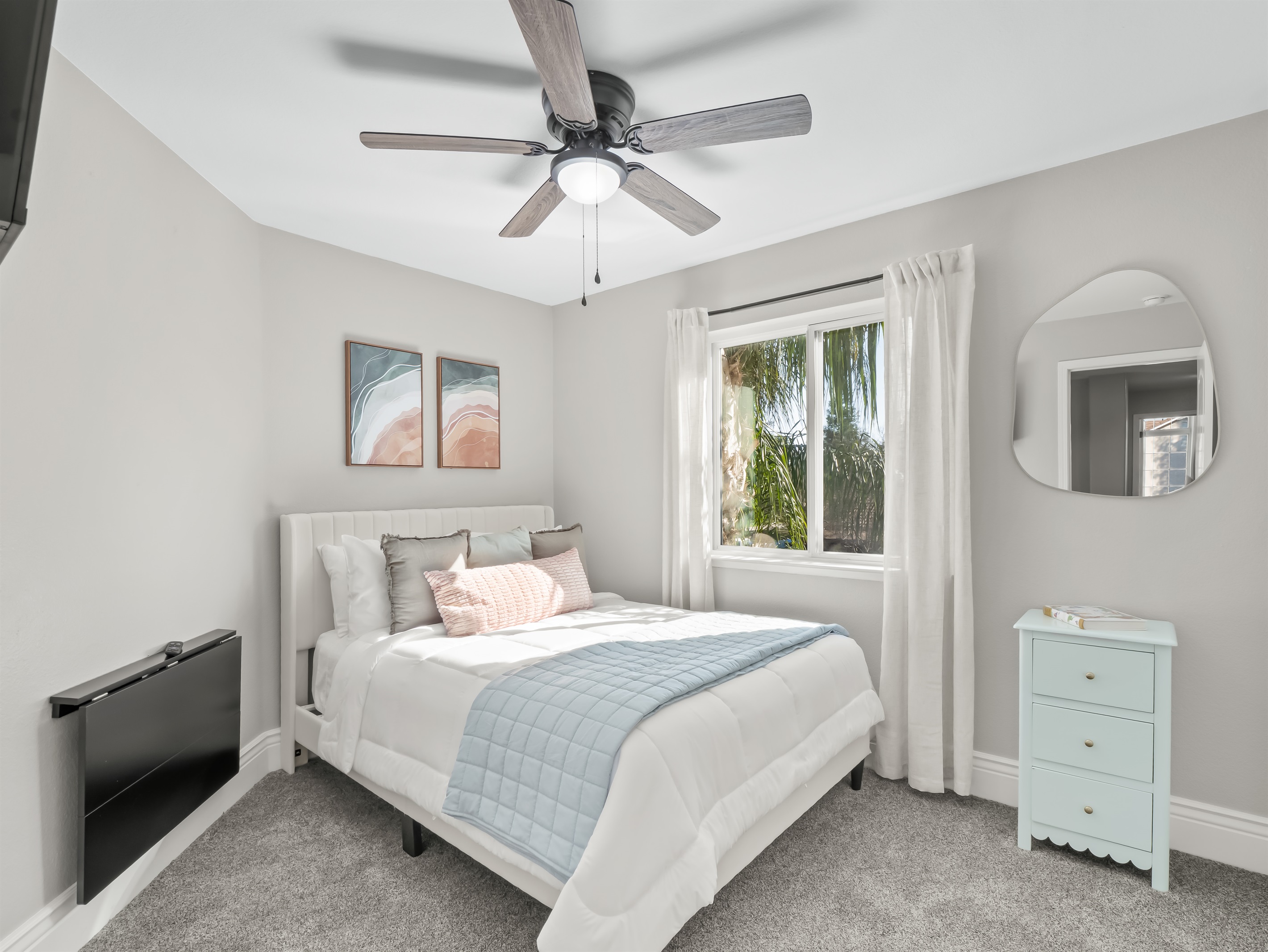 Bright and cozy bedroom with soft carpeting, a comfortable bed, and plenty of natural light—perfect for restful nights after a full day of fun.