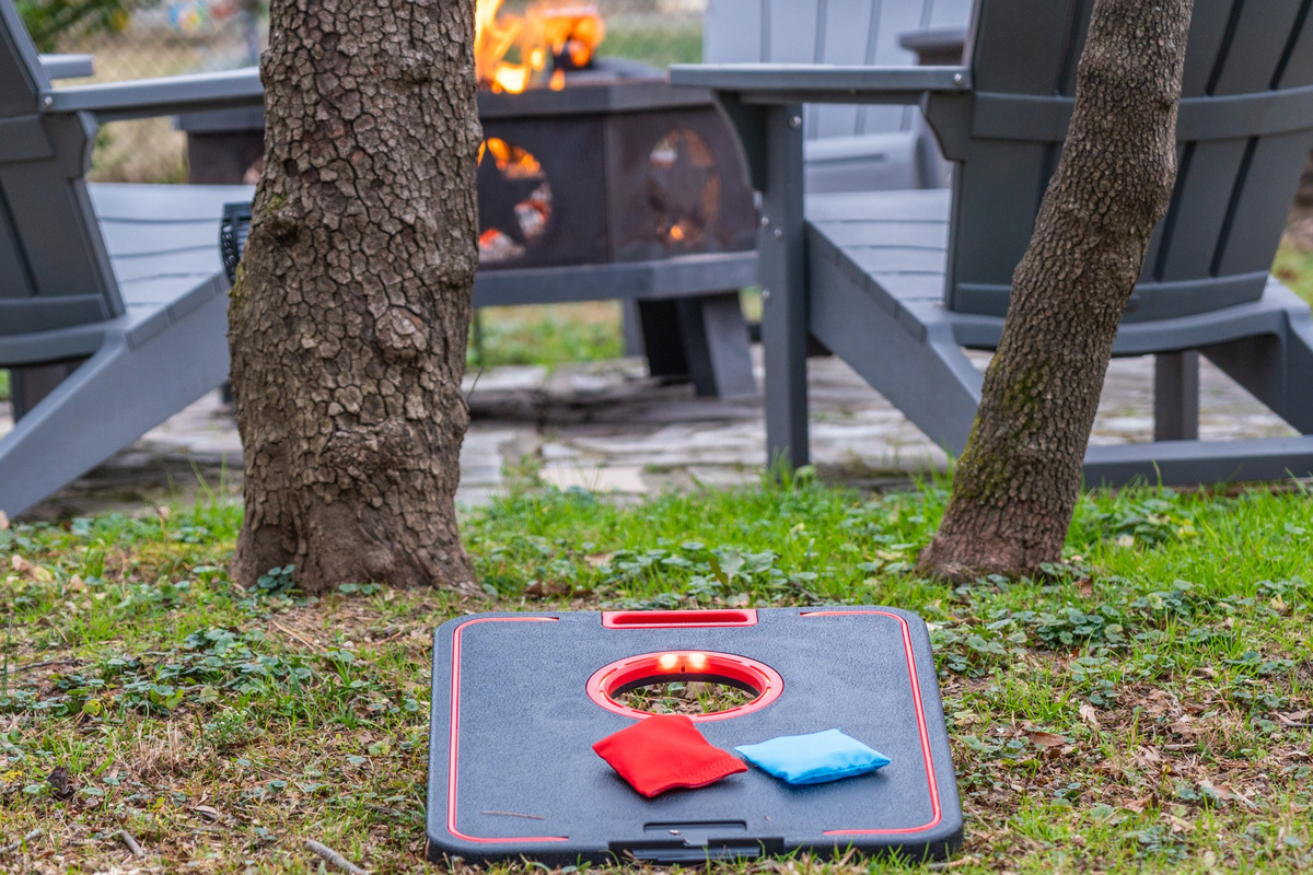 Start a cornhole match in the backyard — bags out, fire lit, and the afternoon gone before anyone notices.