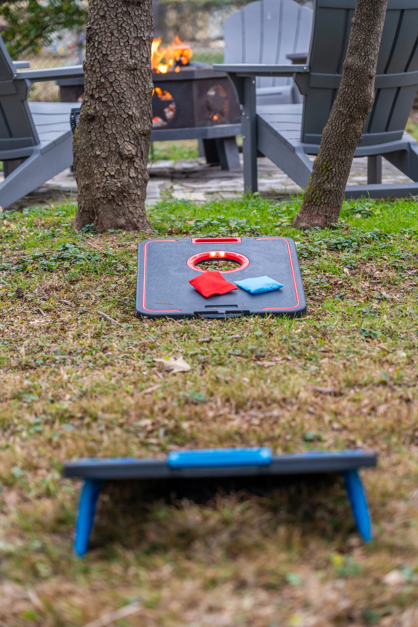 Start a cornhole match in the backyard — bags out, fire lit, and the afternoon gone before anyone notices.