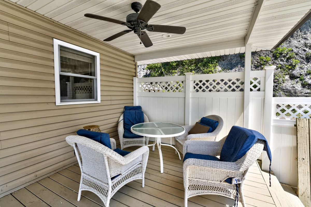 Covered porch with chairs and ceiling fan