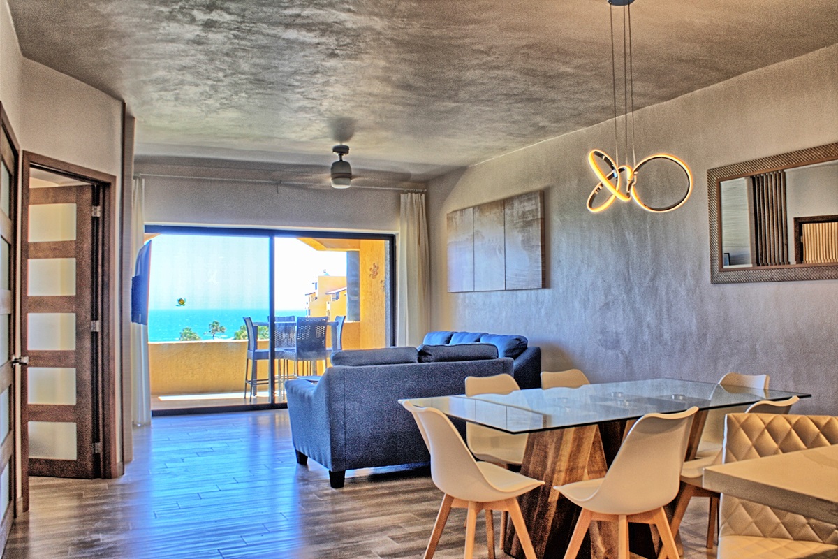 view of dining room, living room and balcony