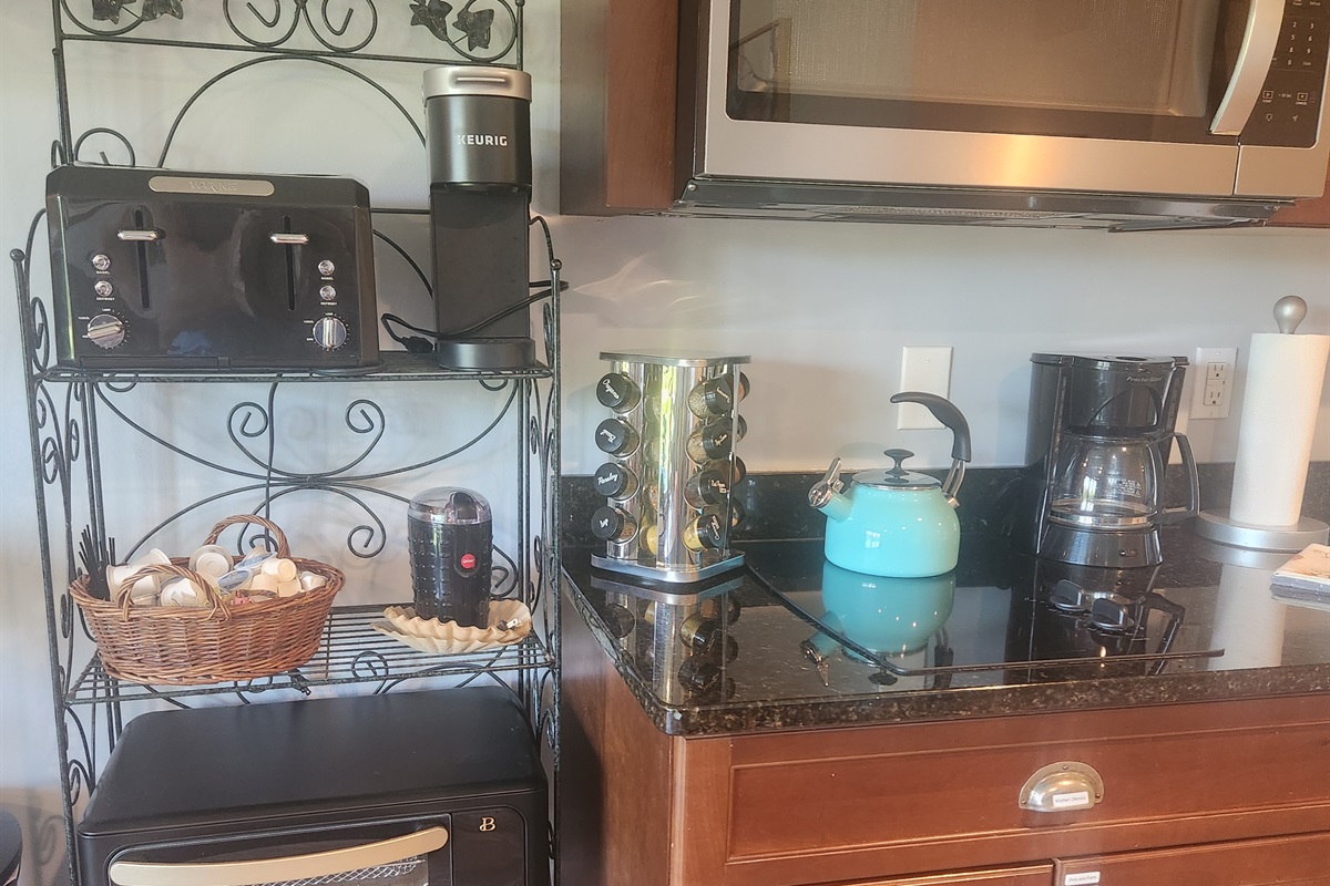 Spices, 2 stove burners, Keurig, and Coffee Pot