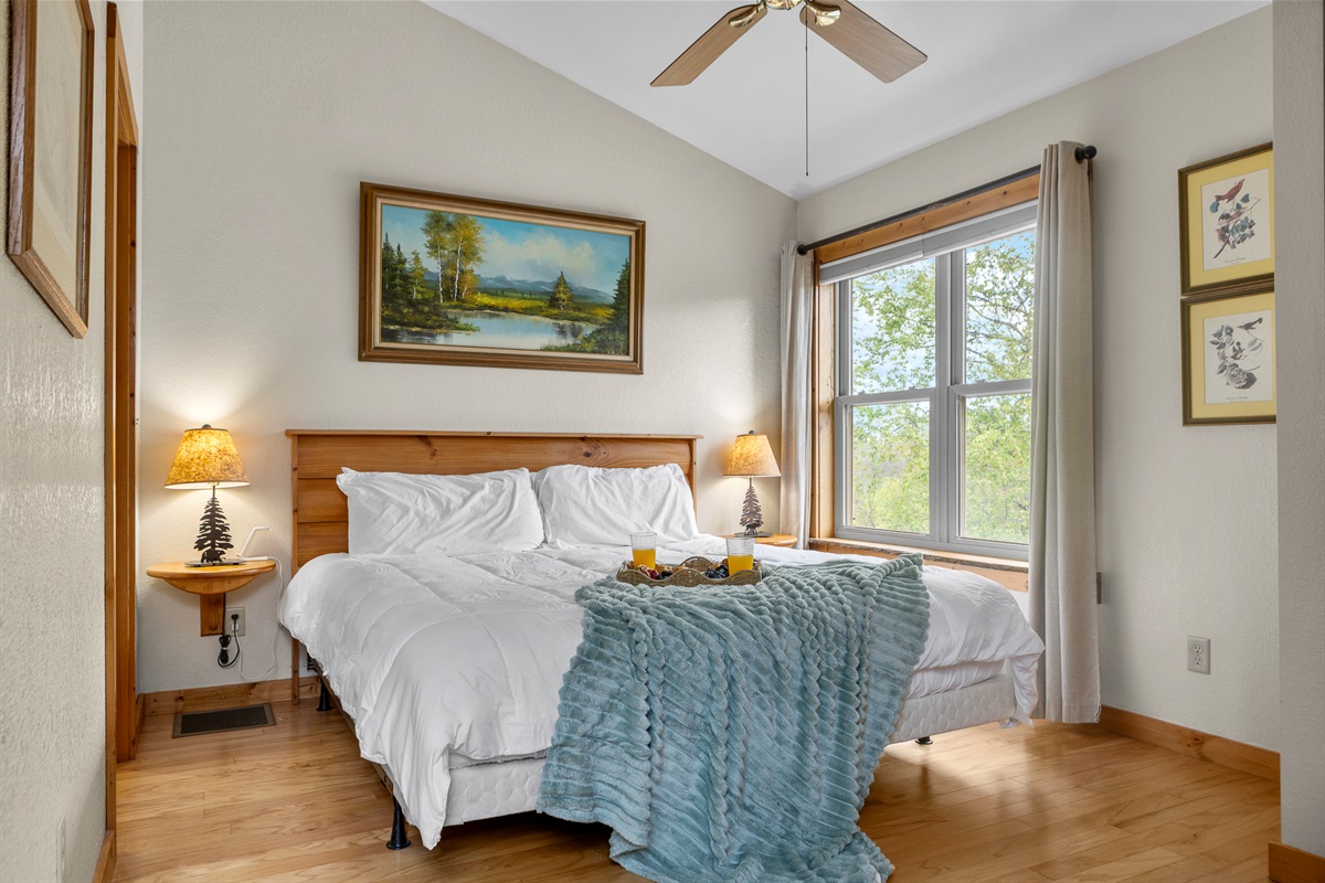 Bedroom Retreat: Bright space with scenic views, soft linens, and warm lighting for restful nights!