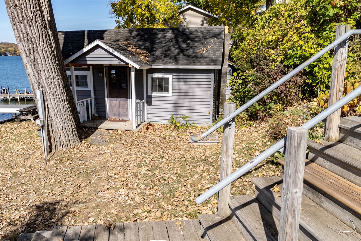 Charming lakefront cabin surrounded by trees — rustic comfort meets unbeatable water views.