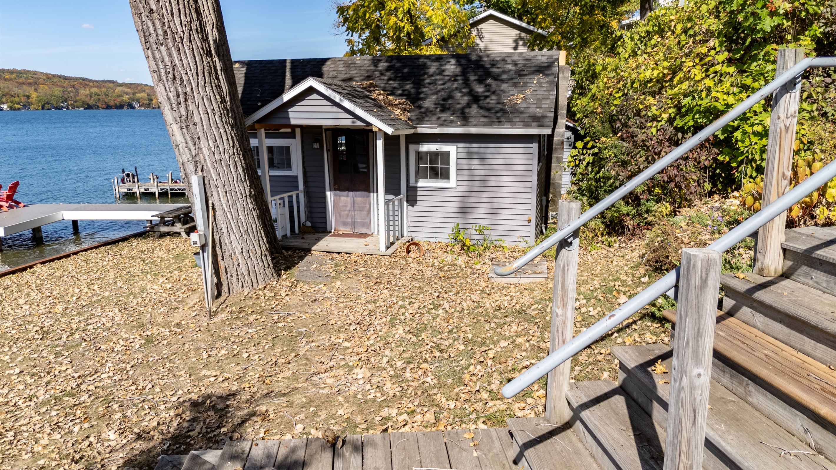 Charming lakefront cabin surrounded by trees — rustic comfort meets unbeatable water views.
