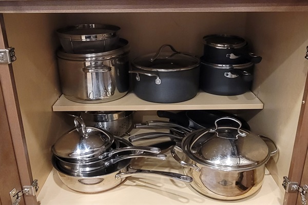 Pots and pans in fully stocked kitchen.