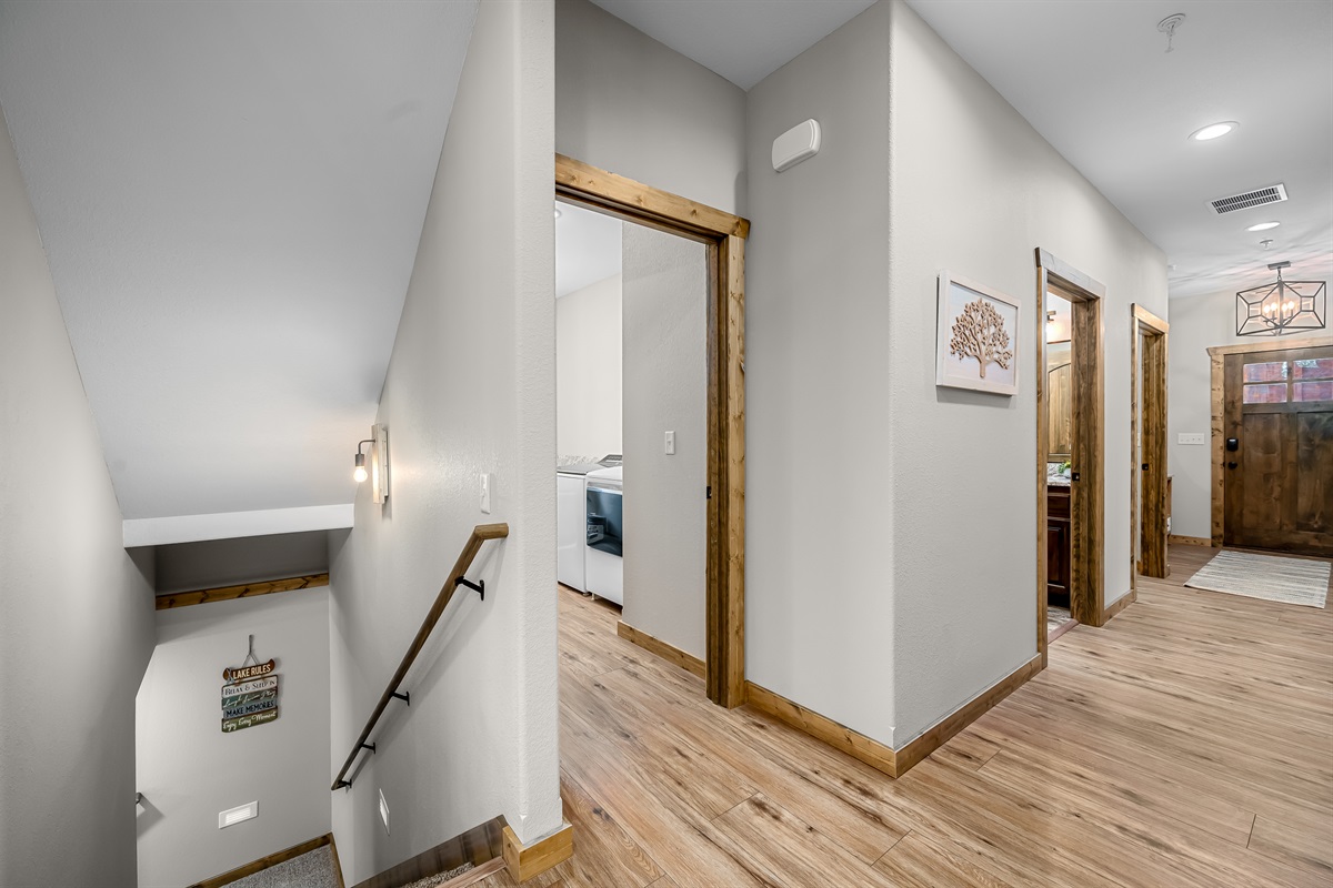 View from front door leading into kitchen with view to laundry room and downstairs
