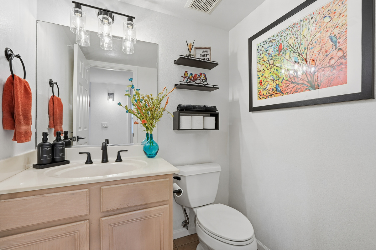 Bathroom 3 with vanity storage, bright mirror lighting, fresh towels, and clean guest-ready essentials.