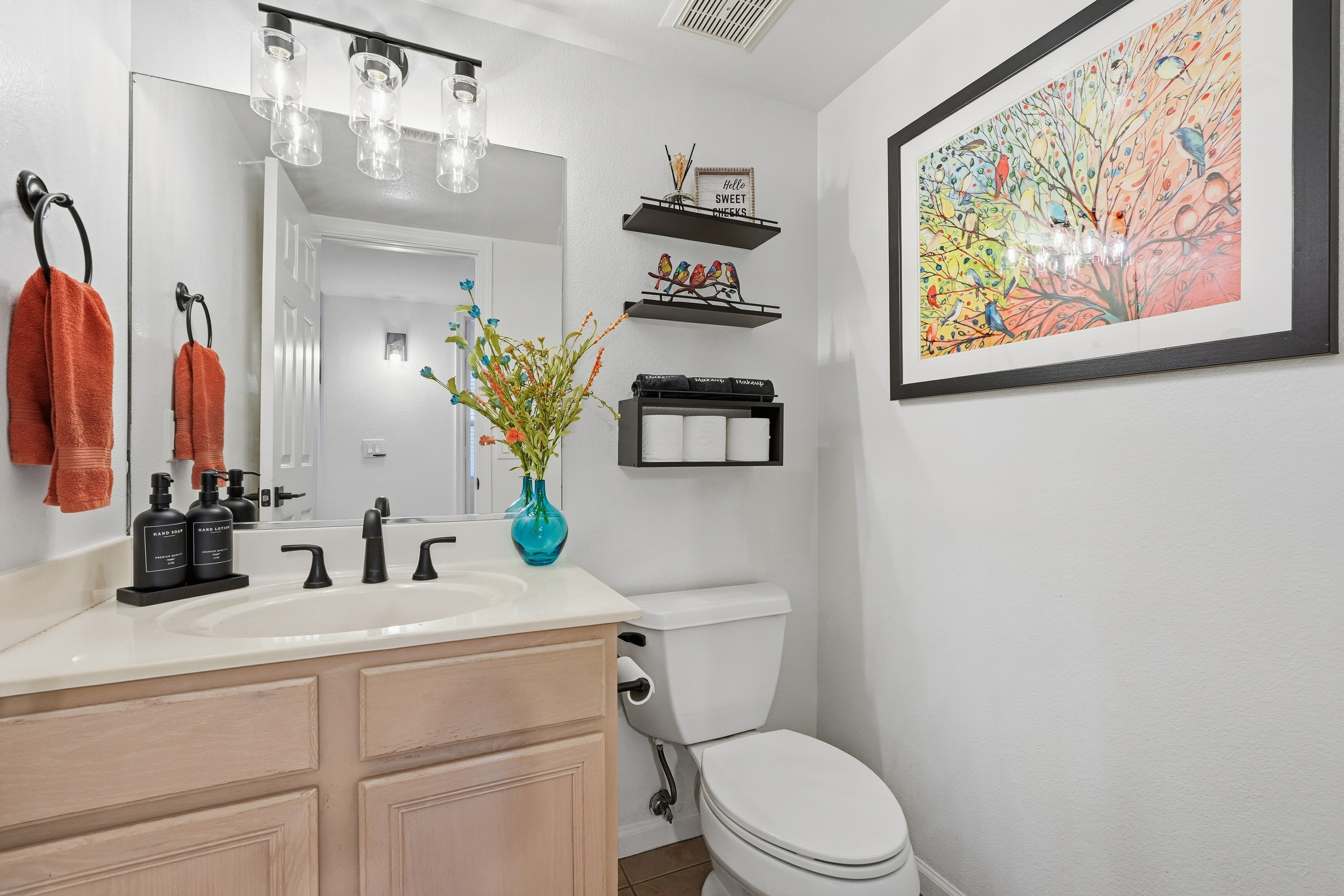 Bathroom 3 with vanity storage, bright mirror lighting, fresh towels, and clean guest-ready essentials.