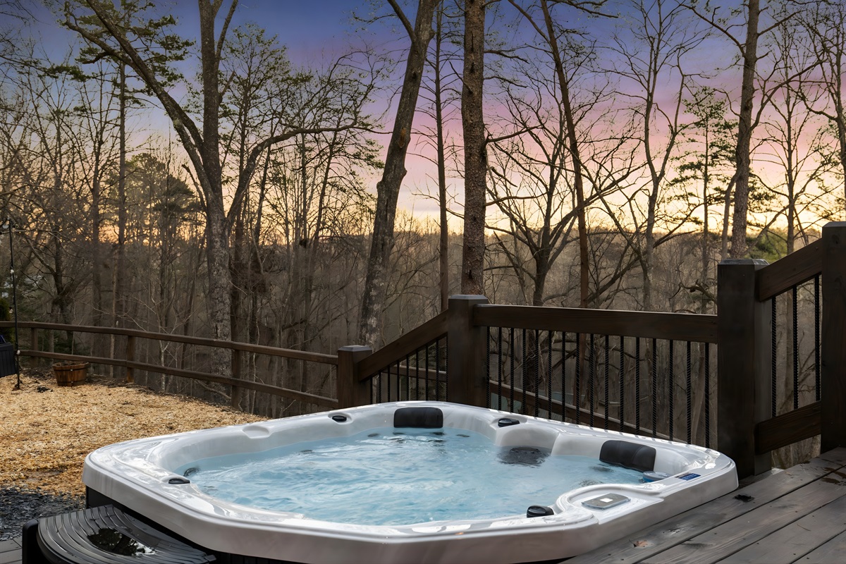 Twilight at the cabin: hot tub bubbling, lights glowing, and nothing but nature around you.