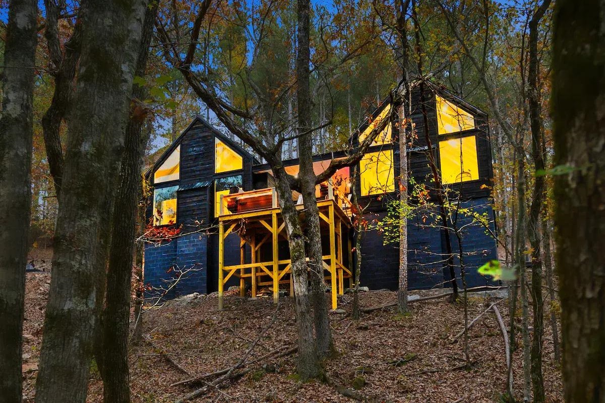 The separate structures of the cabin, connected by a covered breezeway, create a unique and private getaway, perfect for couples seeking intimacy and tranquility.