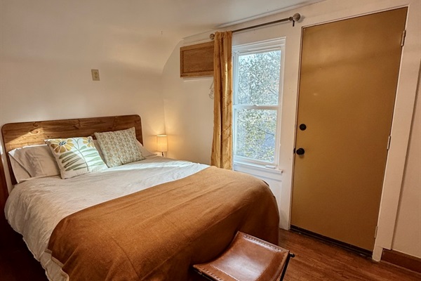 Bedroom with Black Out Curtains and second entrance to the Private Deck.