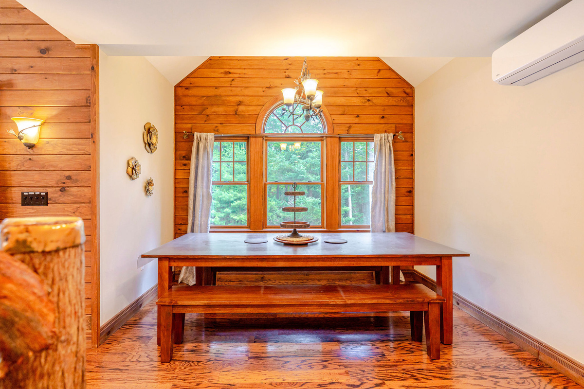 The dining table seats 10, and there are 2 stools in the kitchen.
