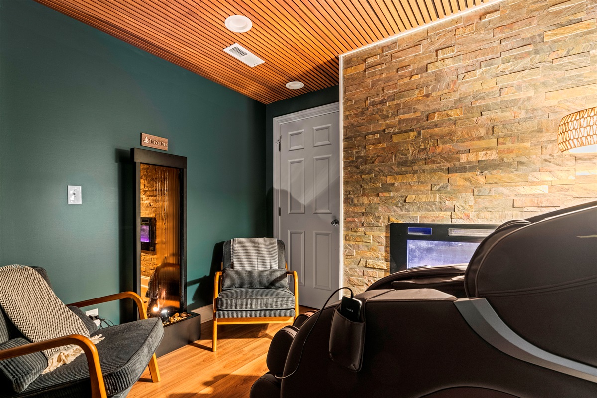 Tranquility meets style — mid-century seating, lighted water feature, and the gentle flicker of a stone-clad fireplace set the tone for your stay