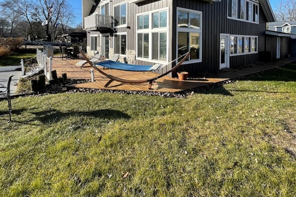Lake side fire pit and hammock perfect for relaxing near the water.